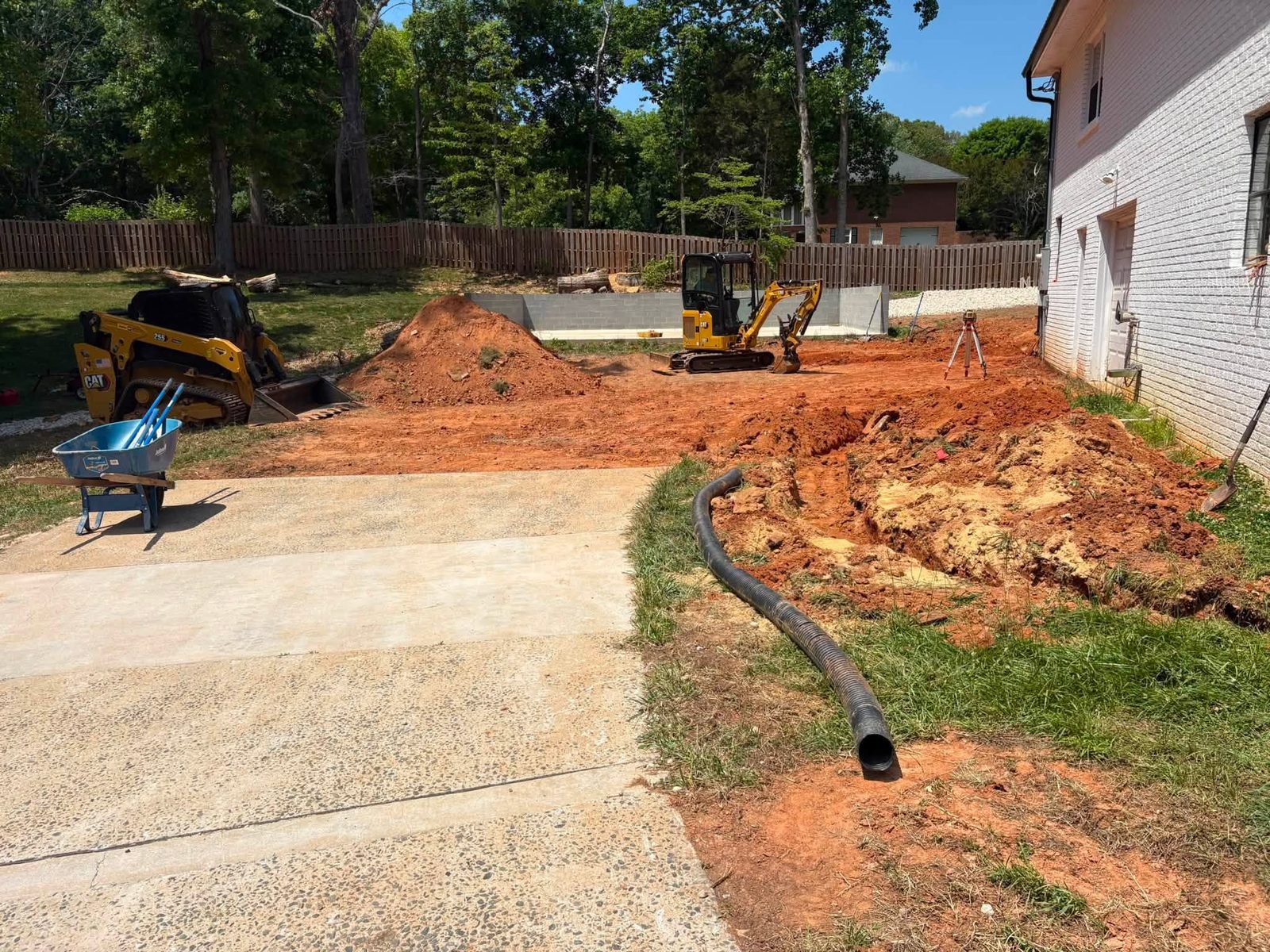 Excavation beside a house with a new drain line going in